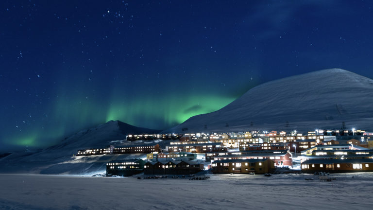 Light and warmth from the town on a cold aurora evening © Jarle Røssland
