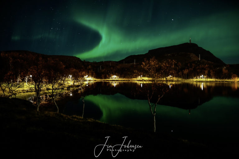 Northern Lights seen over Mount Tyven, with Lake Storvatnet in the foreground © Jim Johansen