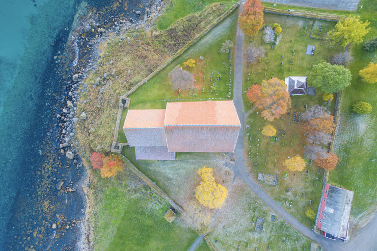 Trondenes Church seen from the air. To the left of the choir you see remnants of two defence towers from the 12th C., older than the church itself itself © Jan Schmitt