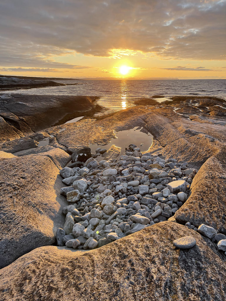 Midnight sun seen from the northern shore. The North Cape island of Magerøya afar © Tamsøya
