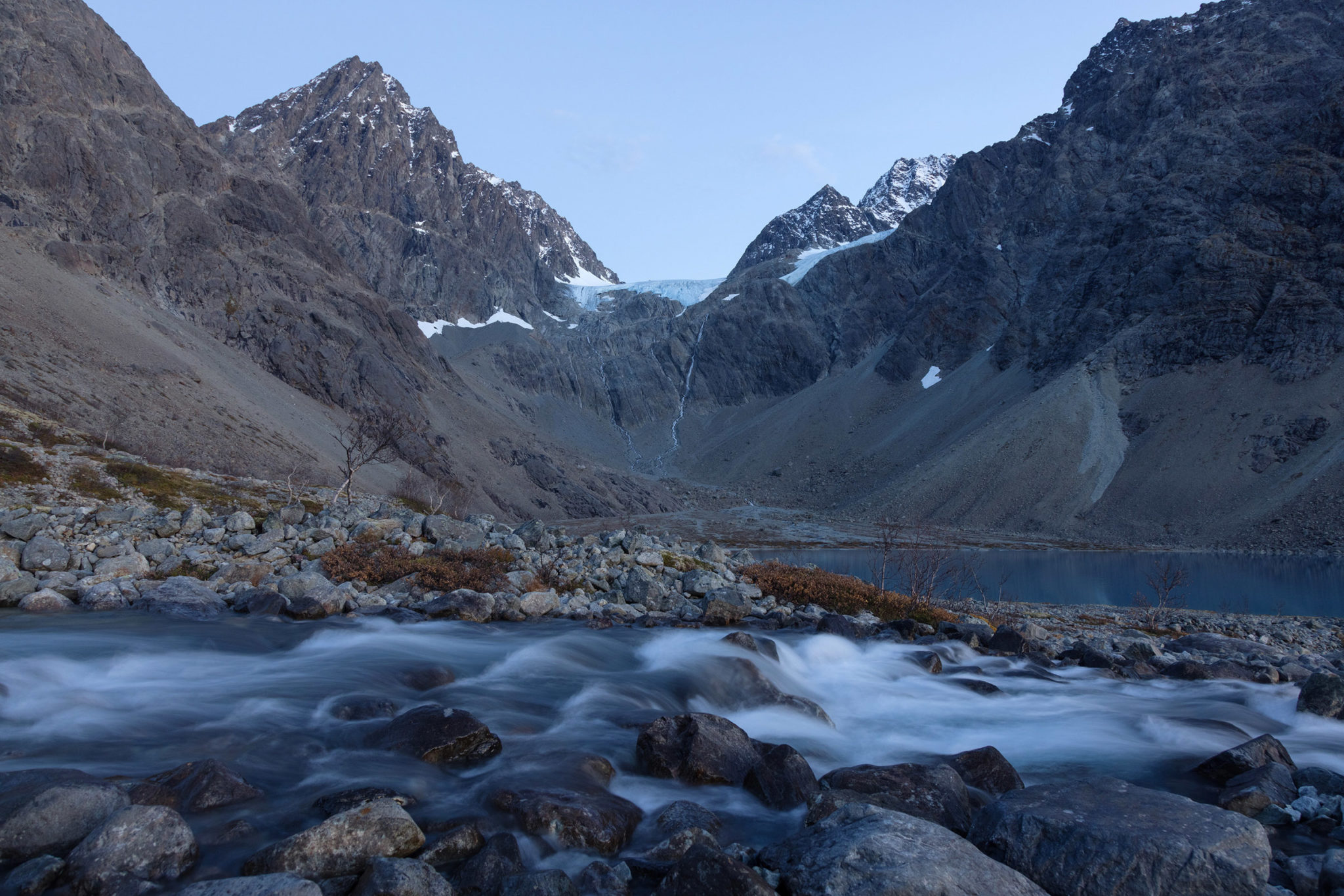 A small glacier, a light dusting of sugar and a gushing river at Lake Blåisvatnet - the Blue Lake © Magnus Askeland