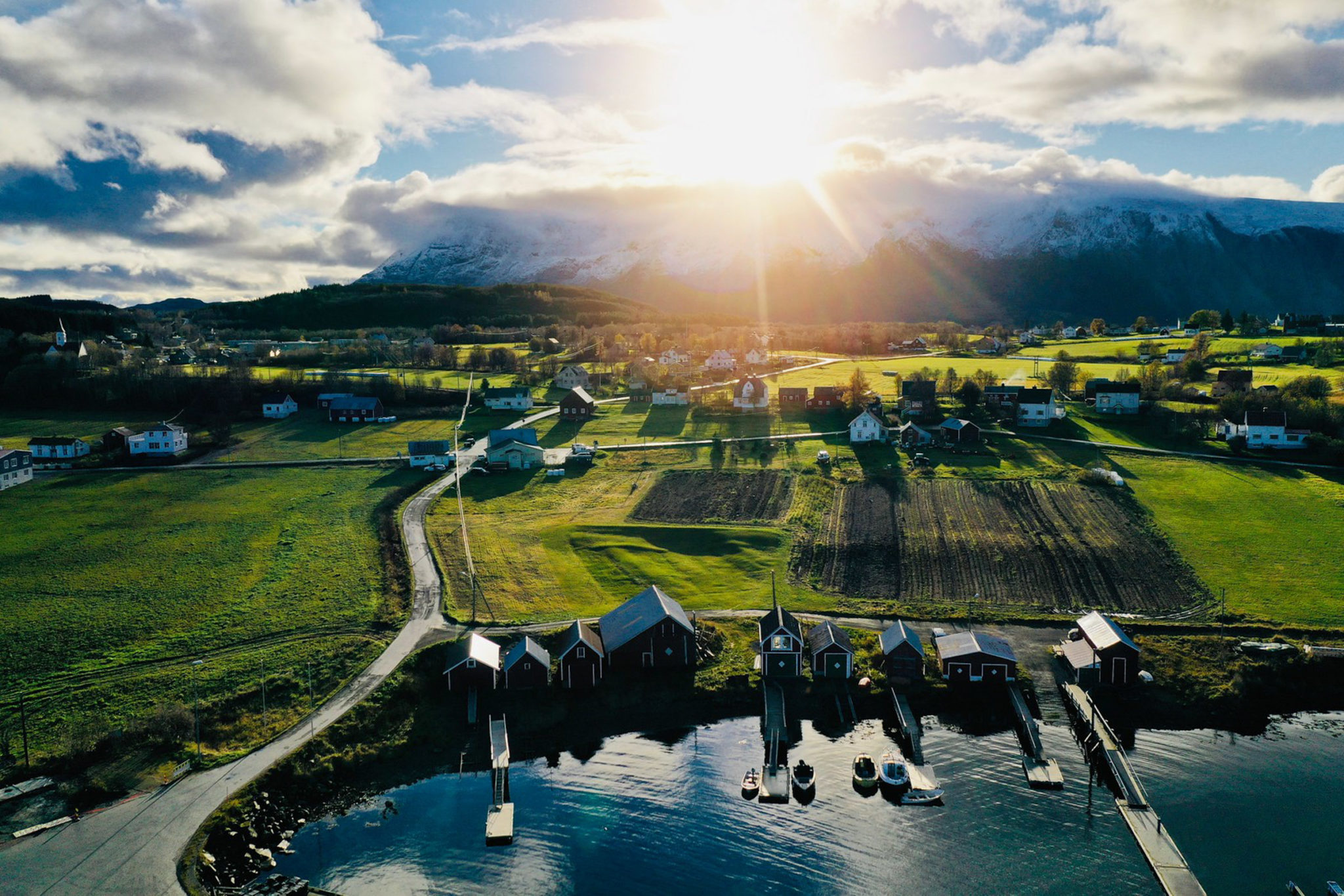 Drone photo from Bjarkøy. You can clearly see the outline of the boathouse. Boathouse number four from the left - the big one - is just below, and you can see the outline in the terrain much easier than up close © Øivind Arvola / Harstad kommune