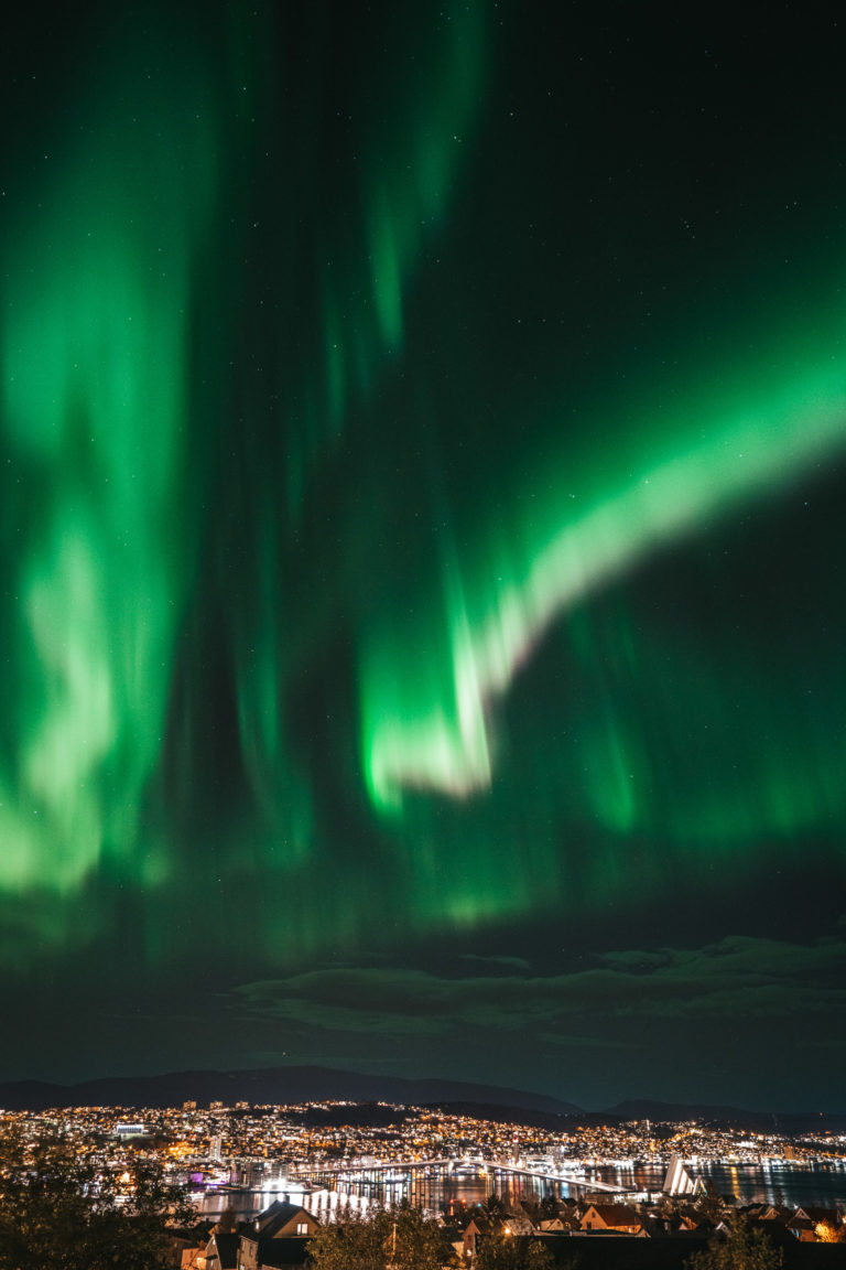 Several Northern Lights ribbons over Tromsø © jensenmedia