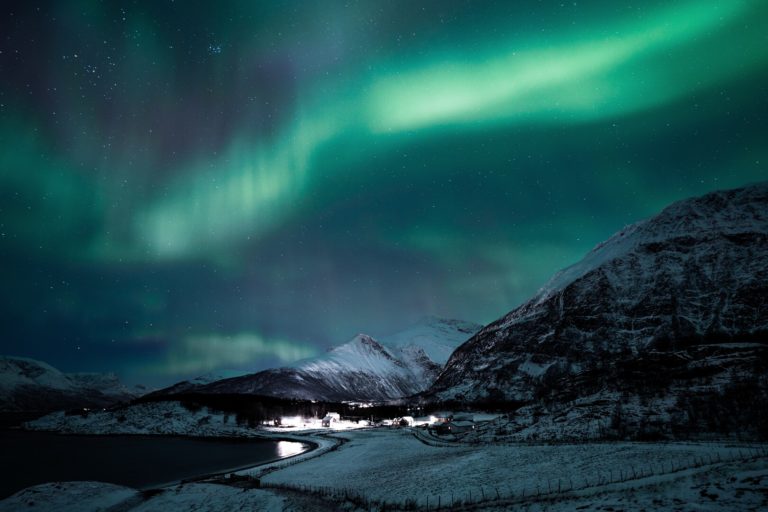 The Northern Lights dancing above the fjords of Lyngenfjord © Petr Pavlíček/Visit Lyngenfjord