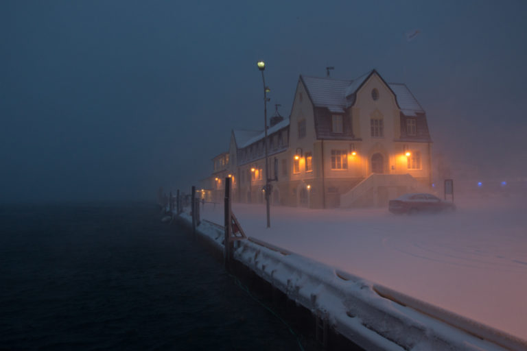 The catamaran terminal in Harstad in drifting snow. HThe building, housing the port authorities, orginates from 1920 © Øivind Arvola / Harstad kommune