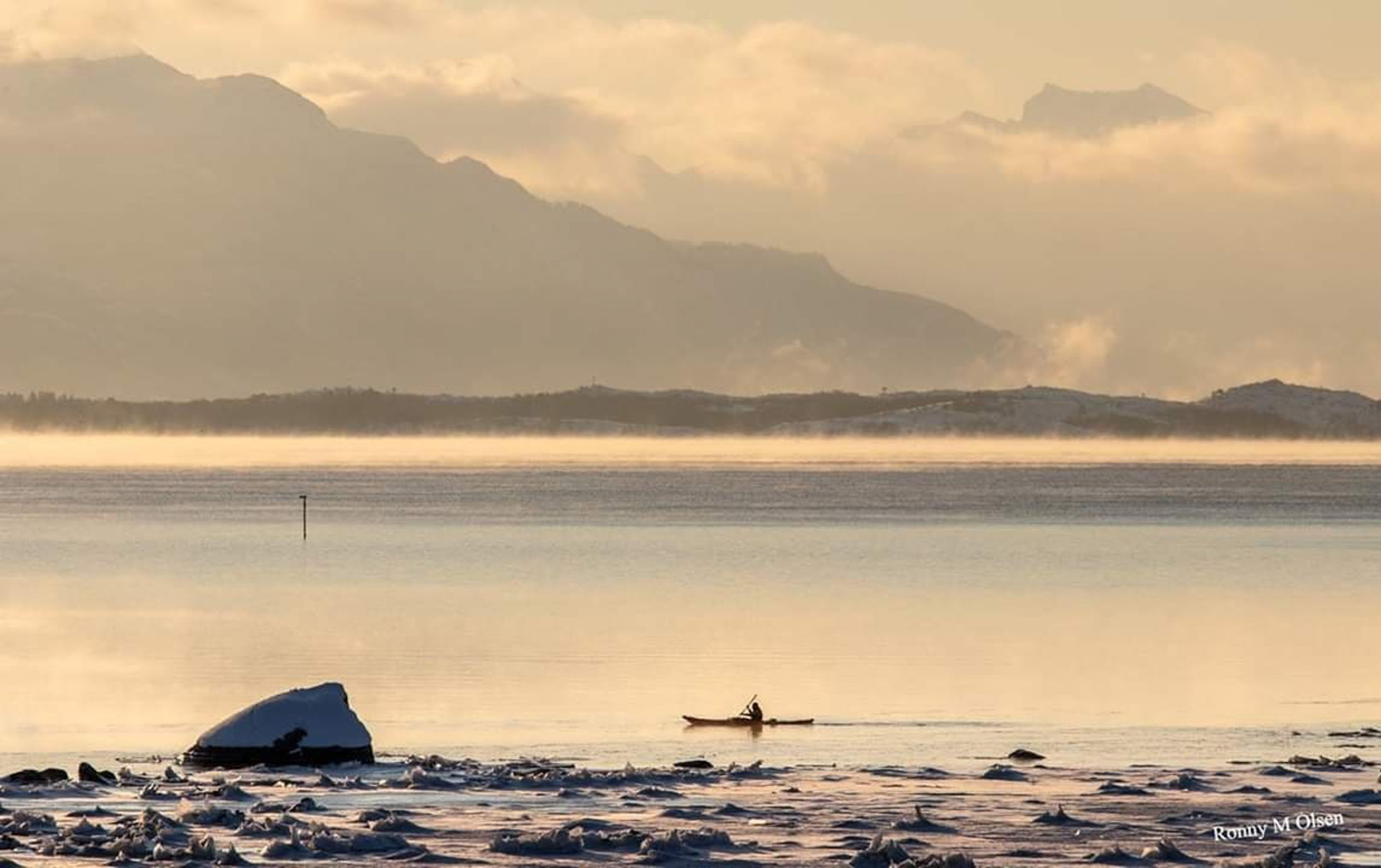 Mid winter kayaking in Tranøybotn. Sea smoke and golden winter light © Ronny M. Olsen / Norwegian Wild